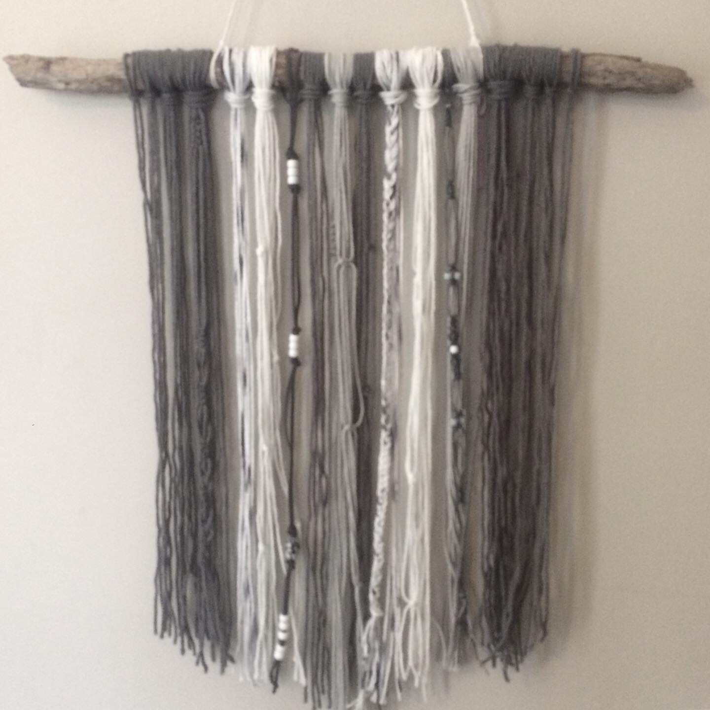 gray and white macrame wall hanging